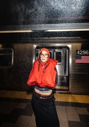 In front of a subway car, hood up